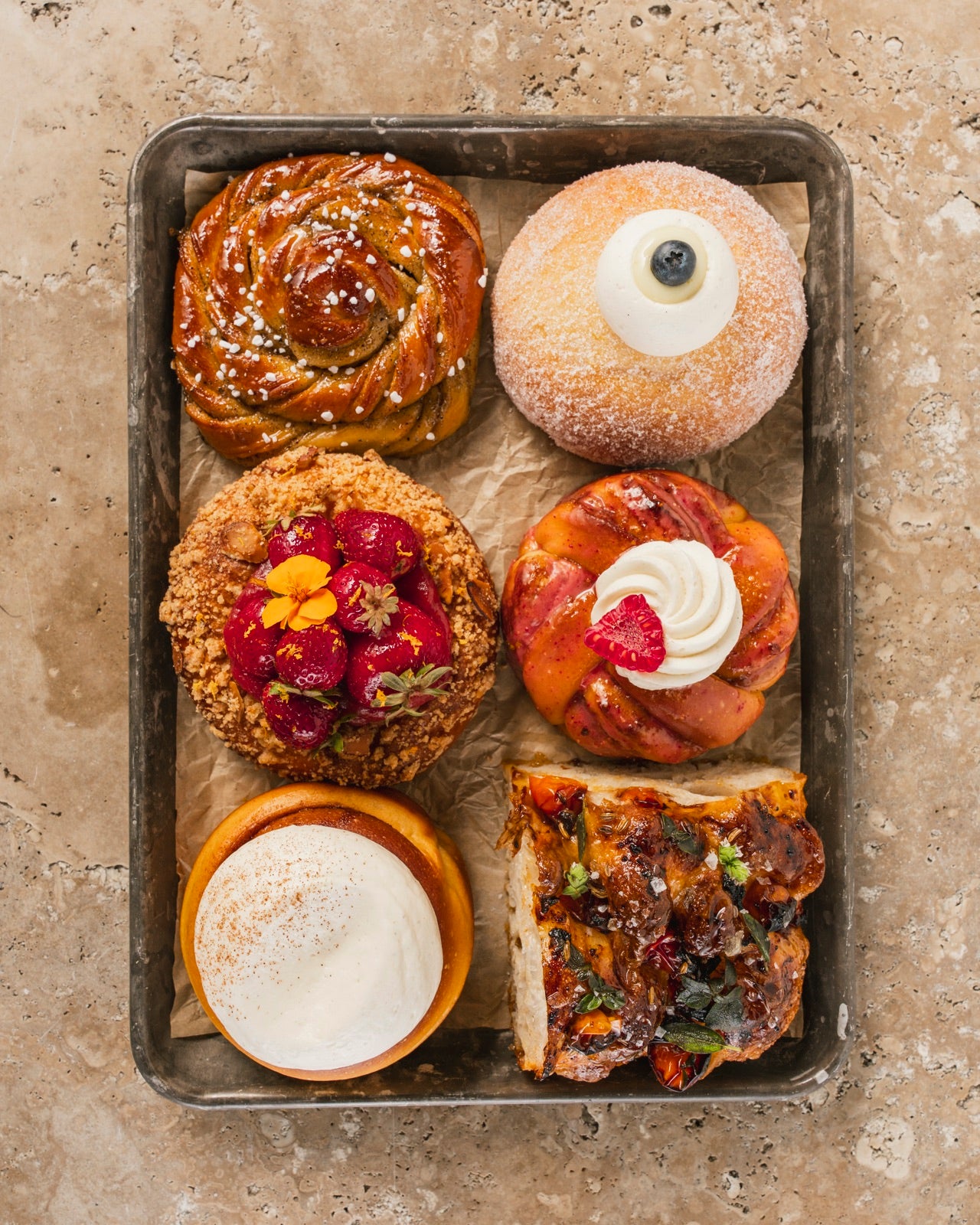 A tray of Manifold buns, pastries, and focaccia, from above